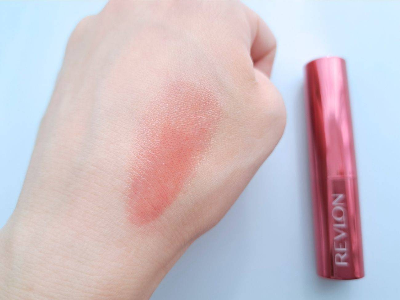 レブロン スーパーラストラス デューイ シャイン リップスティック 007 フライング トゥ ムーンの手元スウォッチ