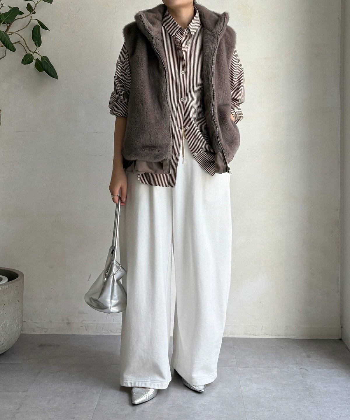 シャツにファーベストを重ねた女性