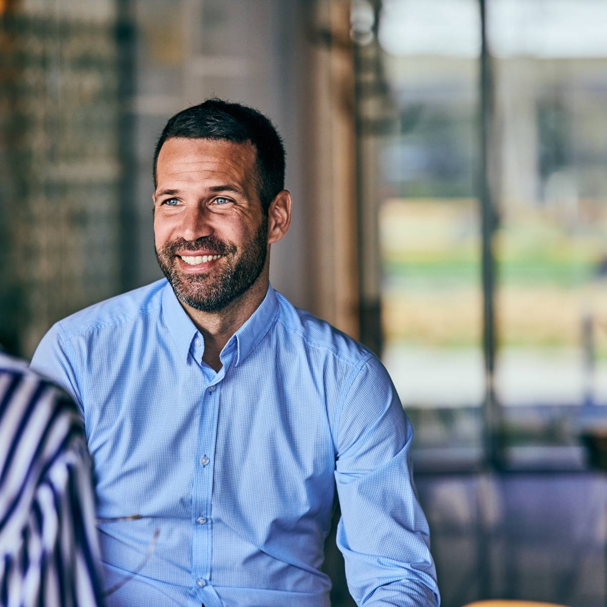 同僚の話を聞く男性