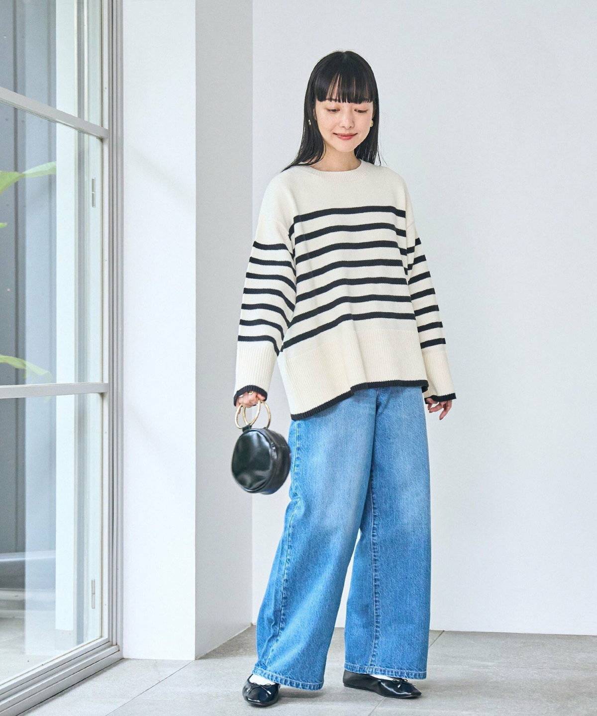 ボーダー柄トップスにデニムを合わせた女性