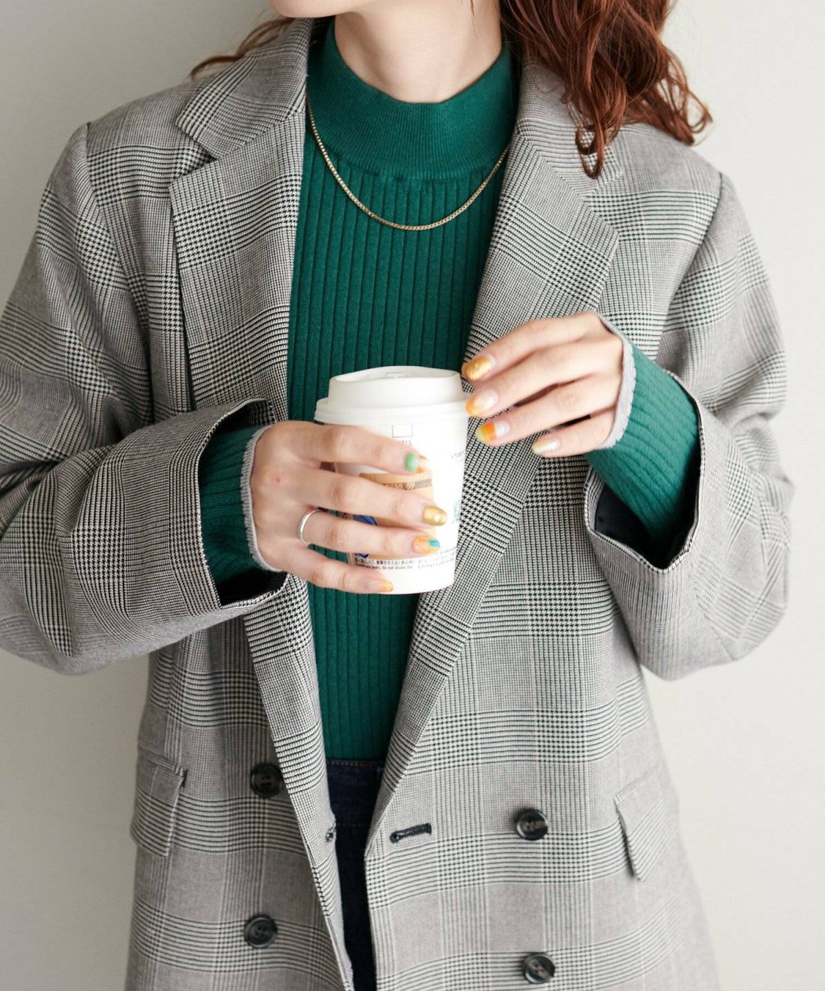 グレーミドルジャケット✕ダークグリーンタートルネックニットの女性