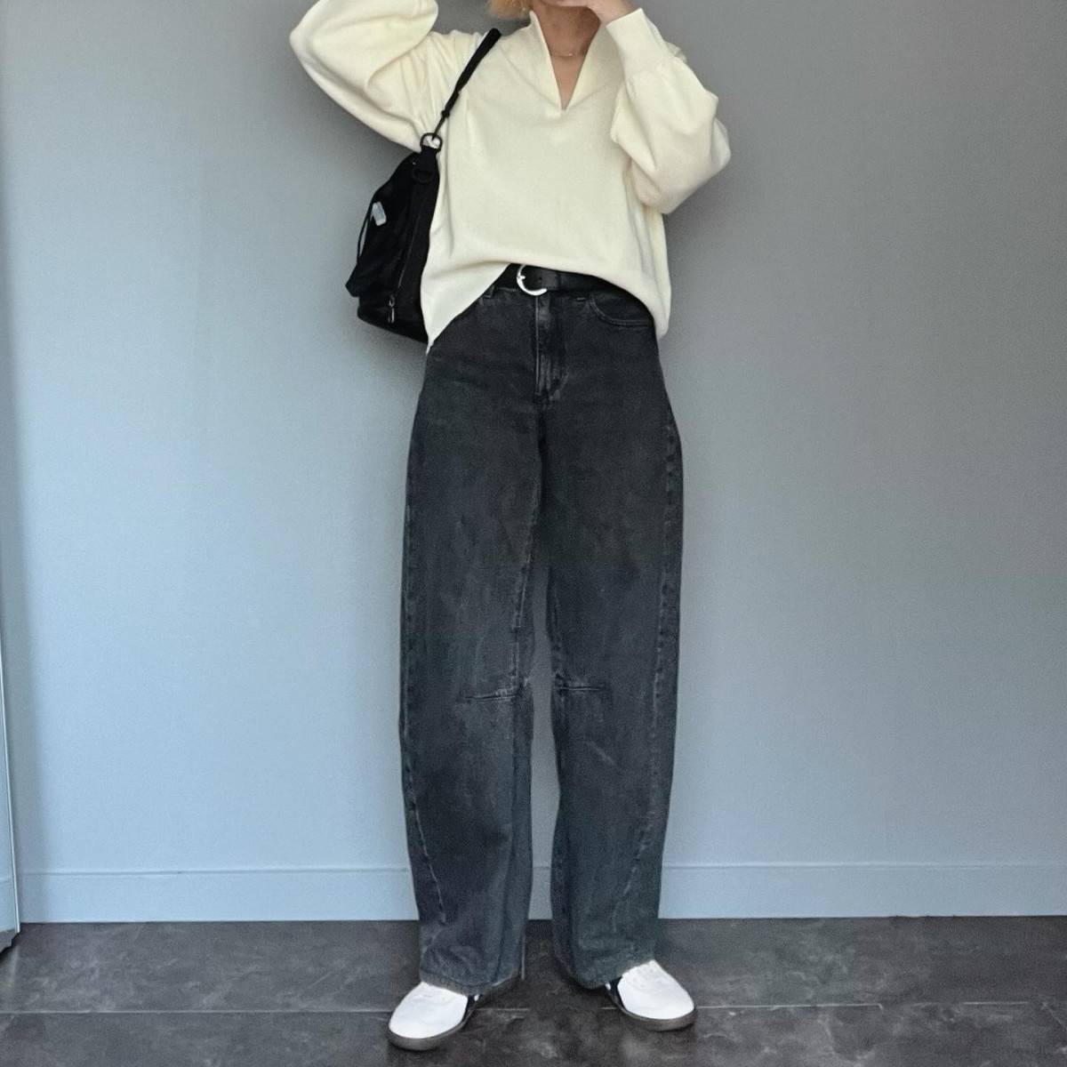 白トップスにデニムパンツを合わせた女性