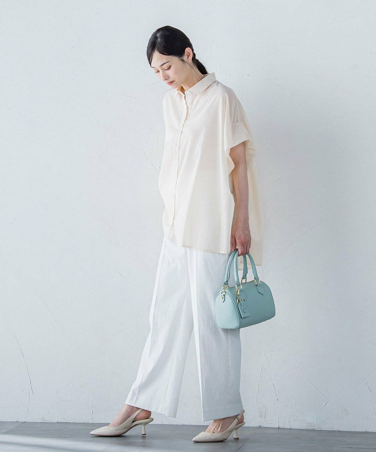 白ブラウスにパンツを合わせた女性