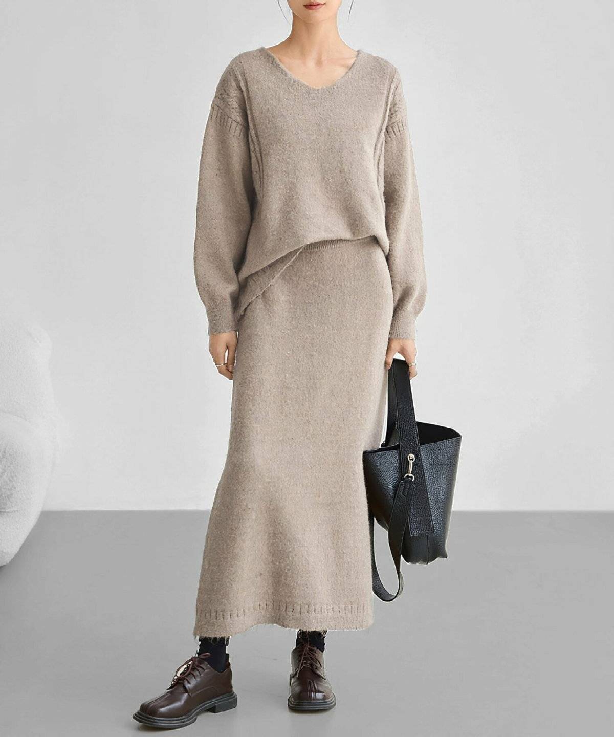 ベージュのニットセットアップを着た女性