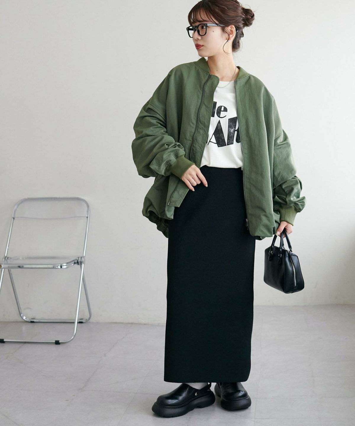 グリーンのアウターを羽織った女性