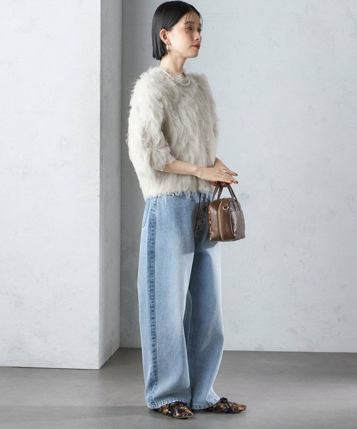 白ニットにデニムを合わせた女性