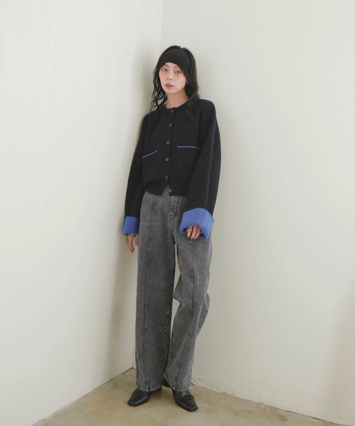 黒カーディガンにデニムを合わせた女性