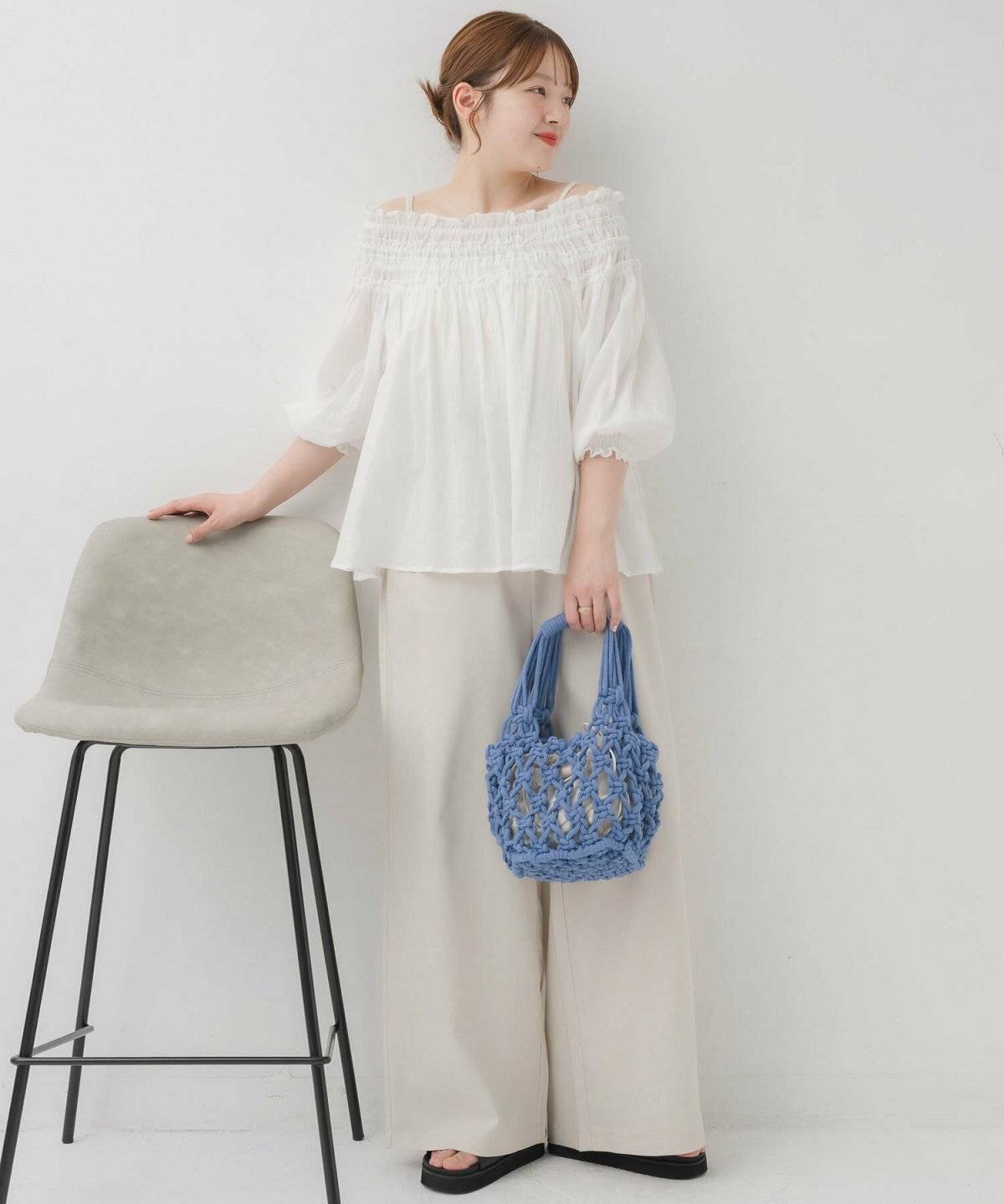 白ブラウスにパンツを合わせた女性