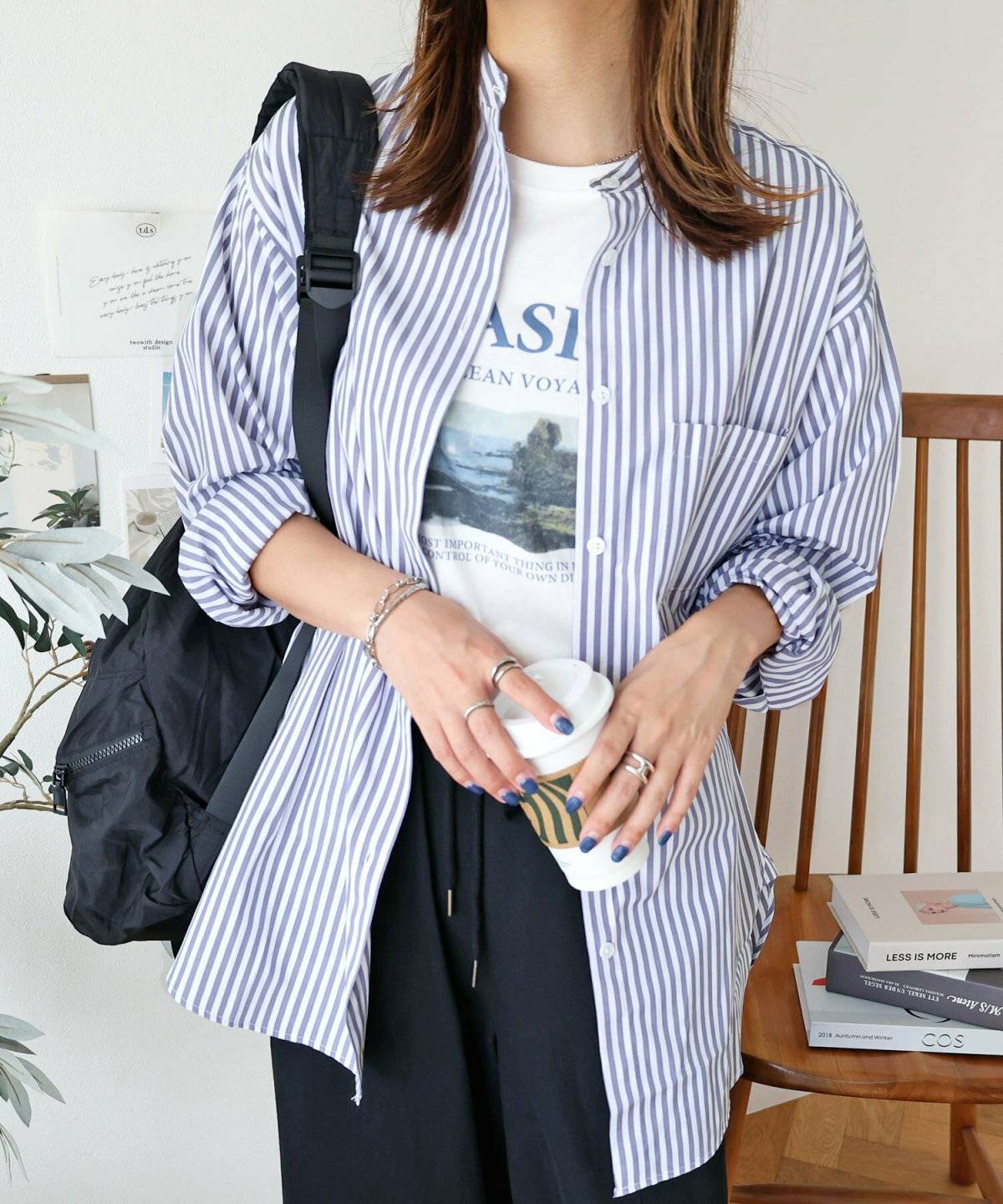 モノトーンコーデにストライプ柄シャツを合わせた女性