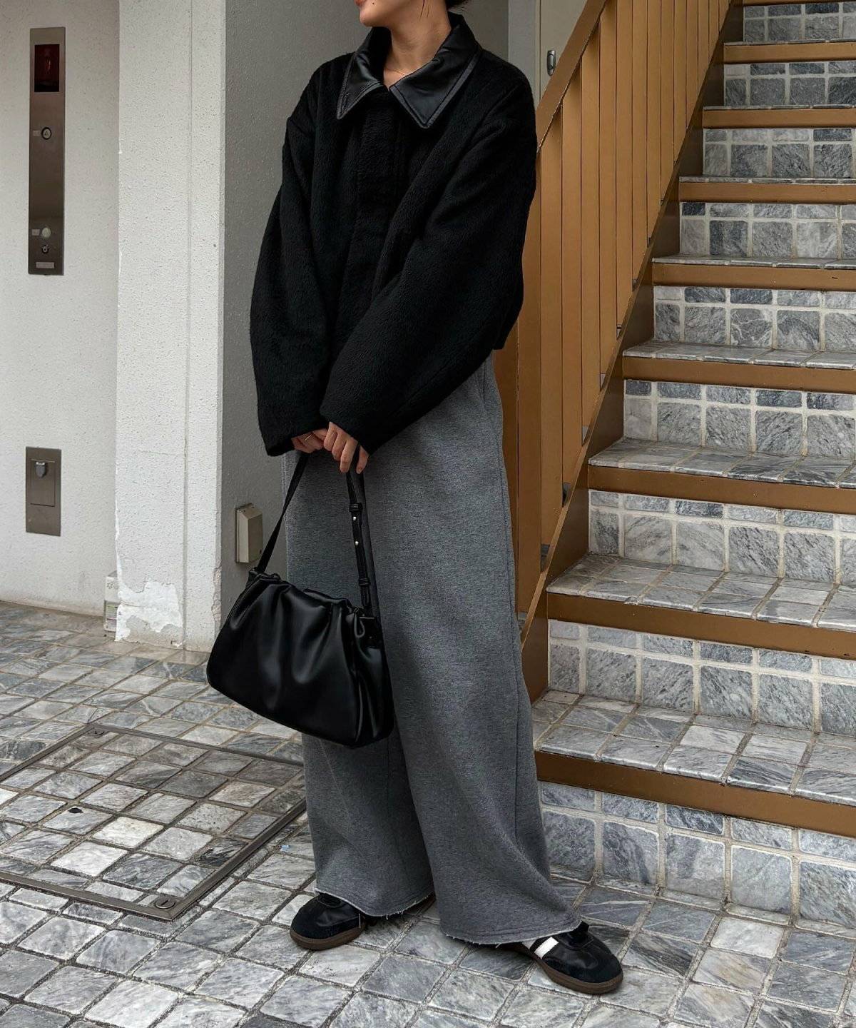 黒コートにパンツを合わせた女性