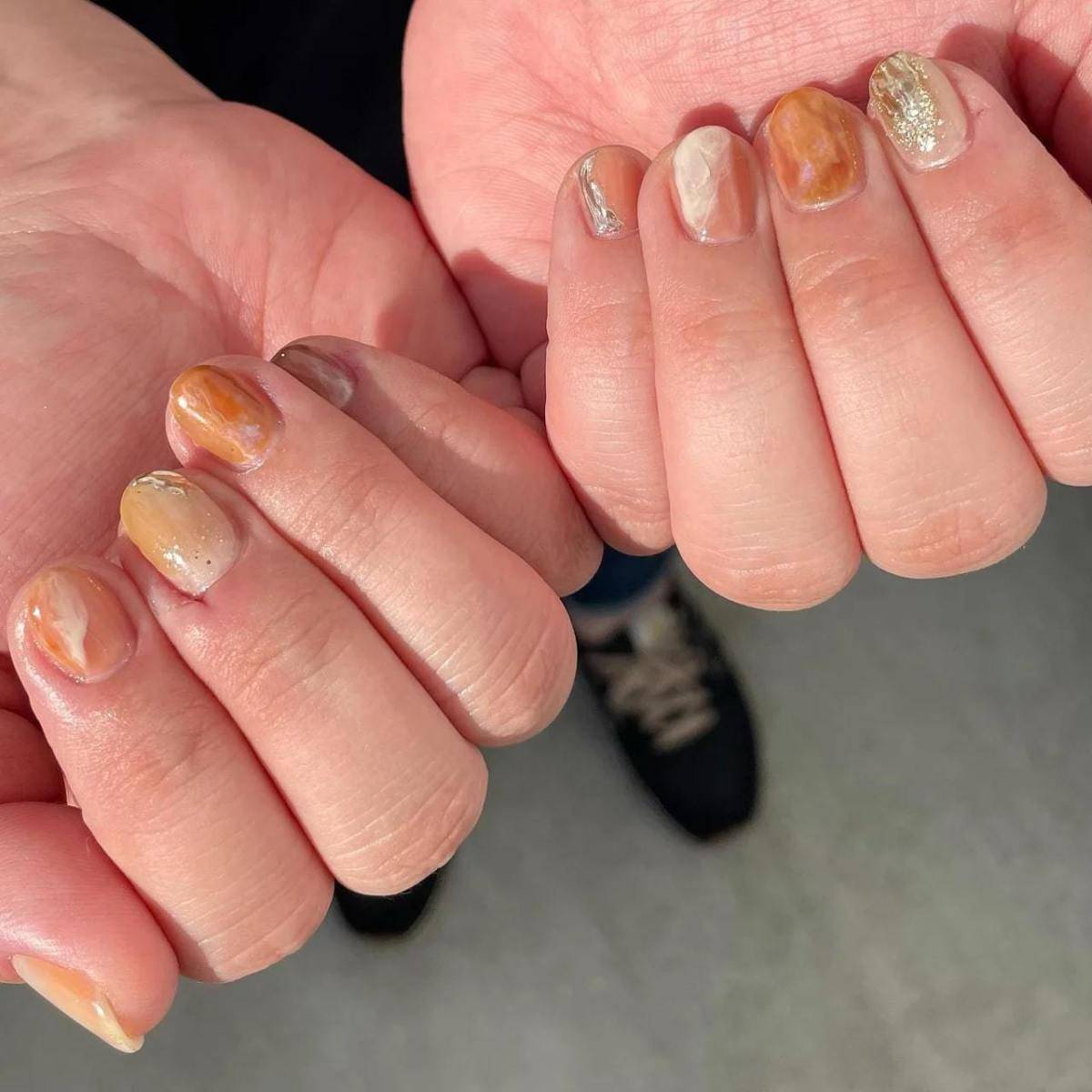 透け感オレンジベージュのキラキラネイル