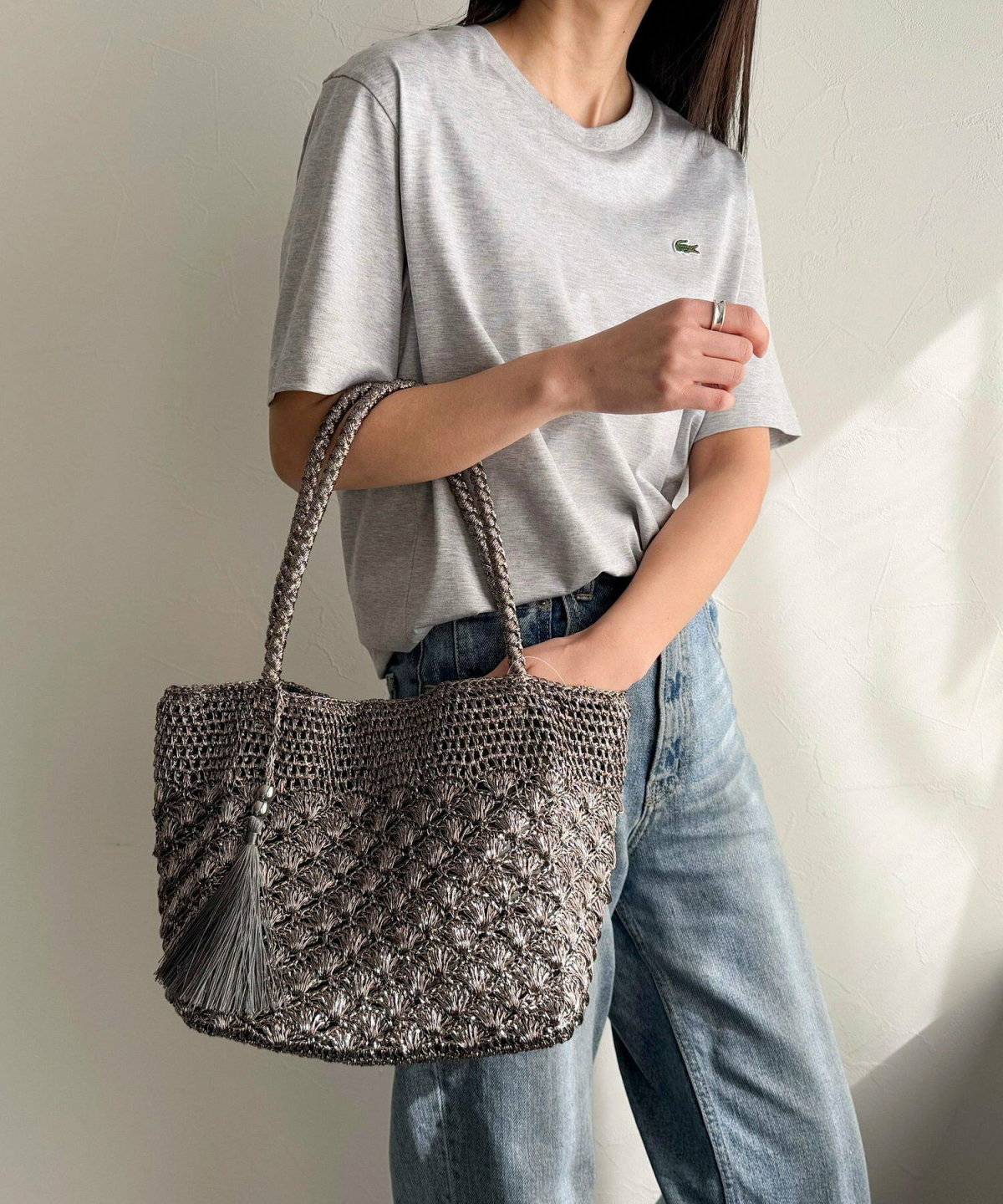 グレーのTシャツにパンツを合わせた女性