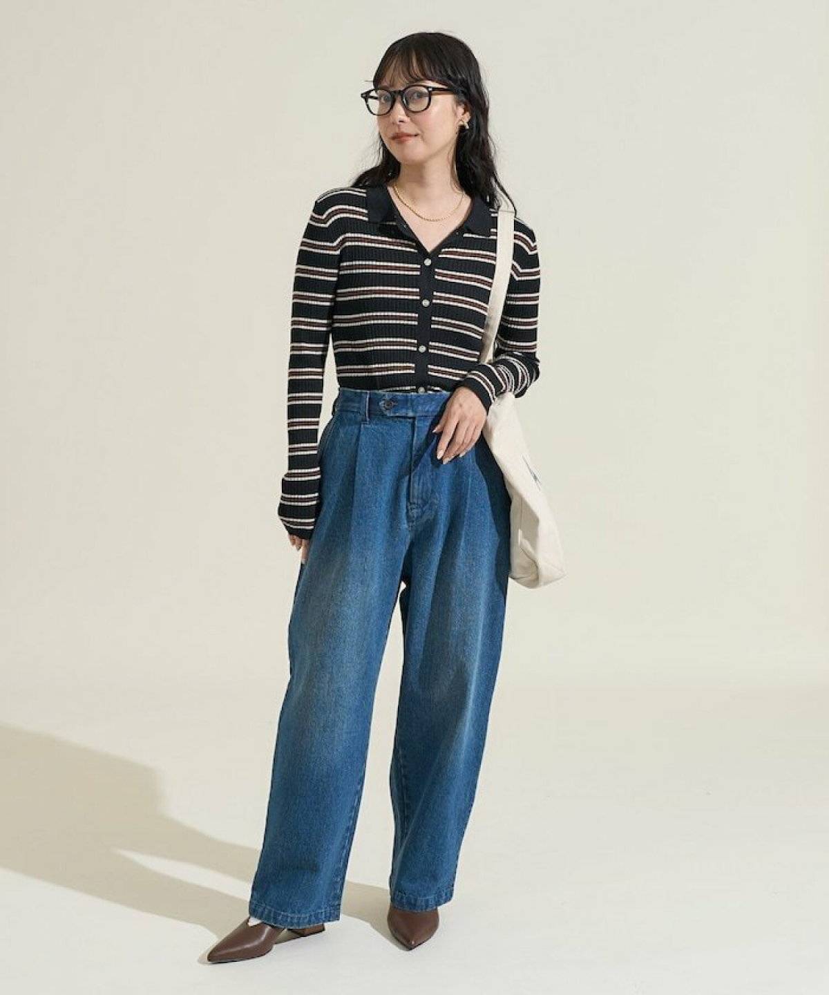 ボーダー柄トップスに黒パンツを合わせた女性