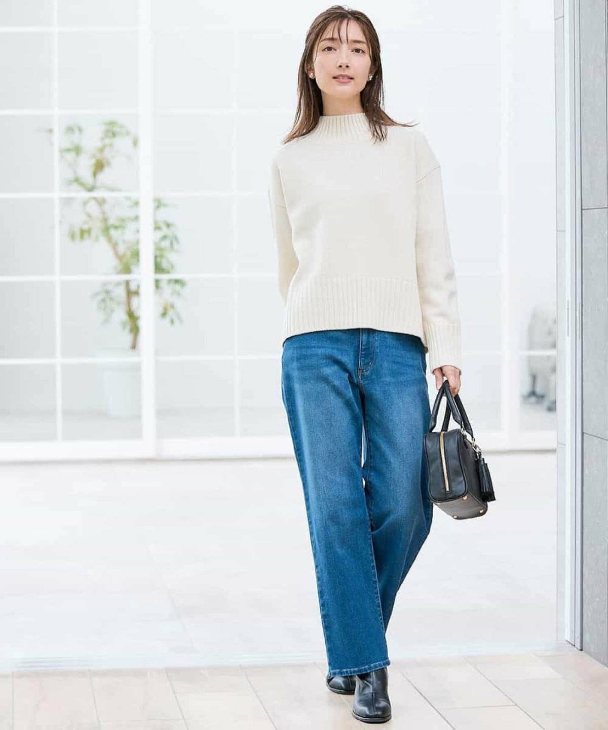 白ニットにデニムを合わせた女性