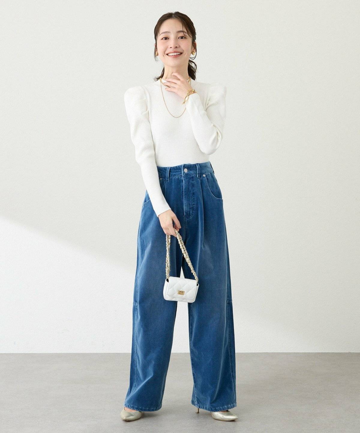 白トップスにデニムを合わせた女性