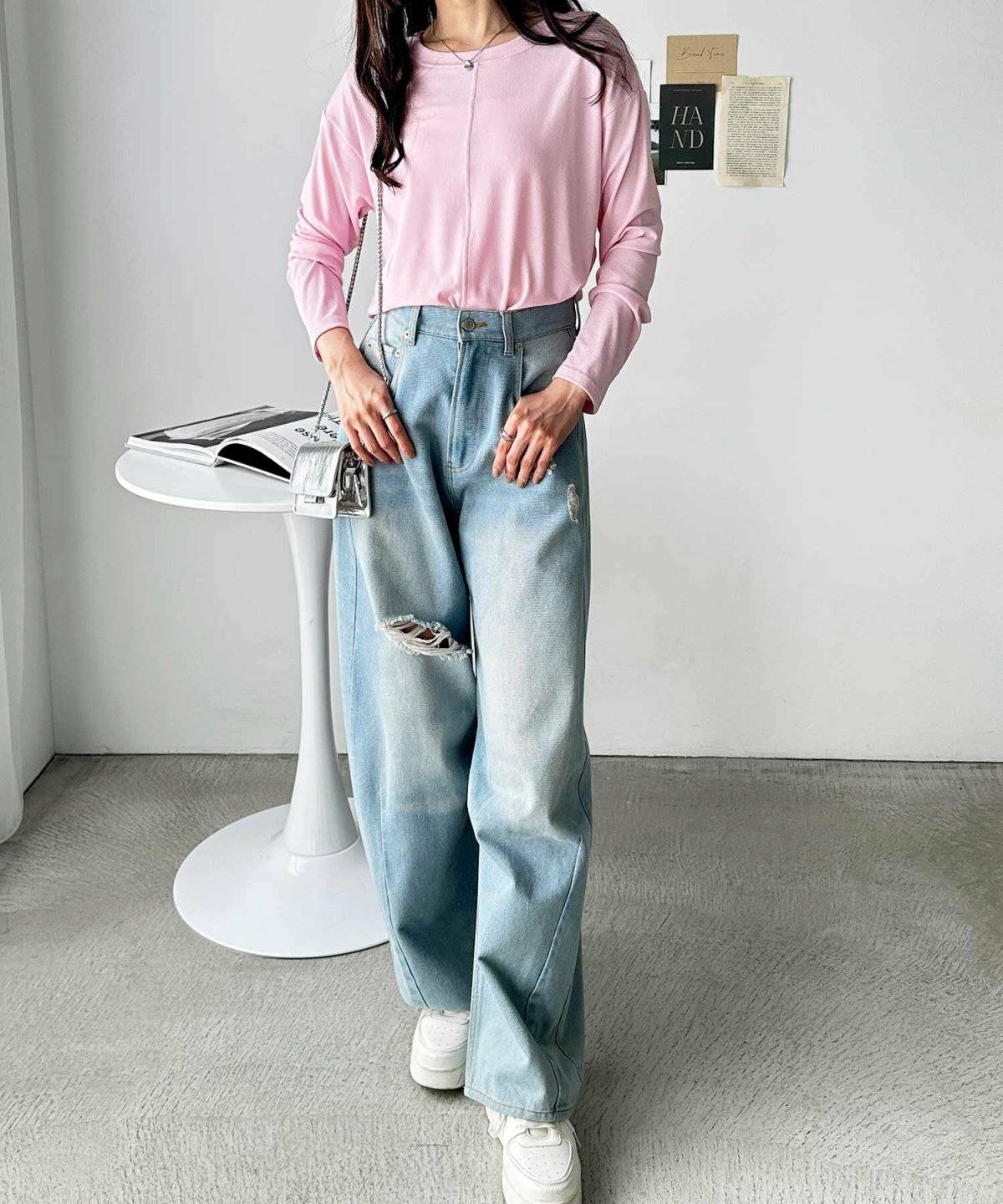 シアートップスにデニムを合わせた女性