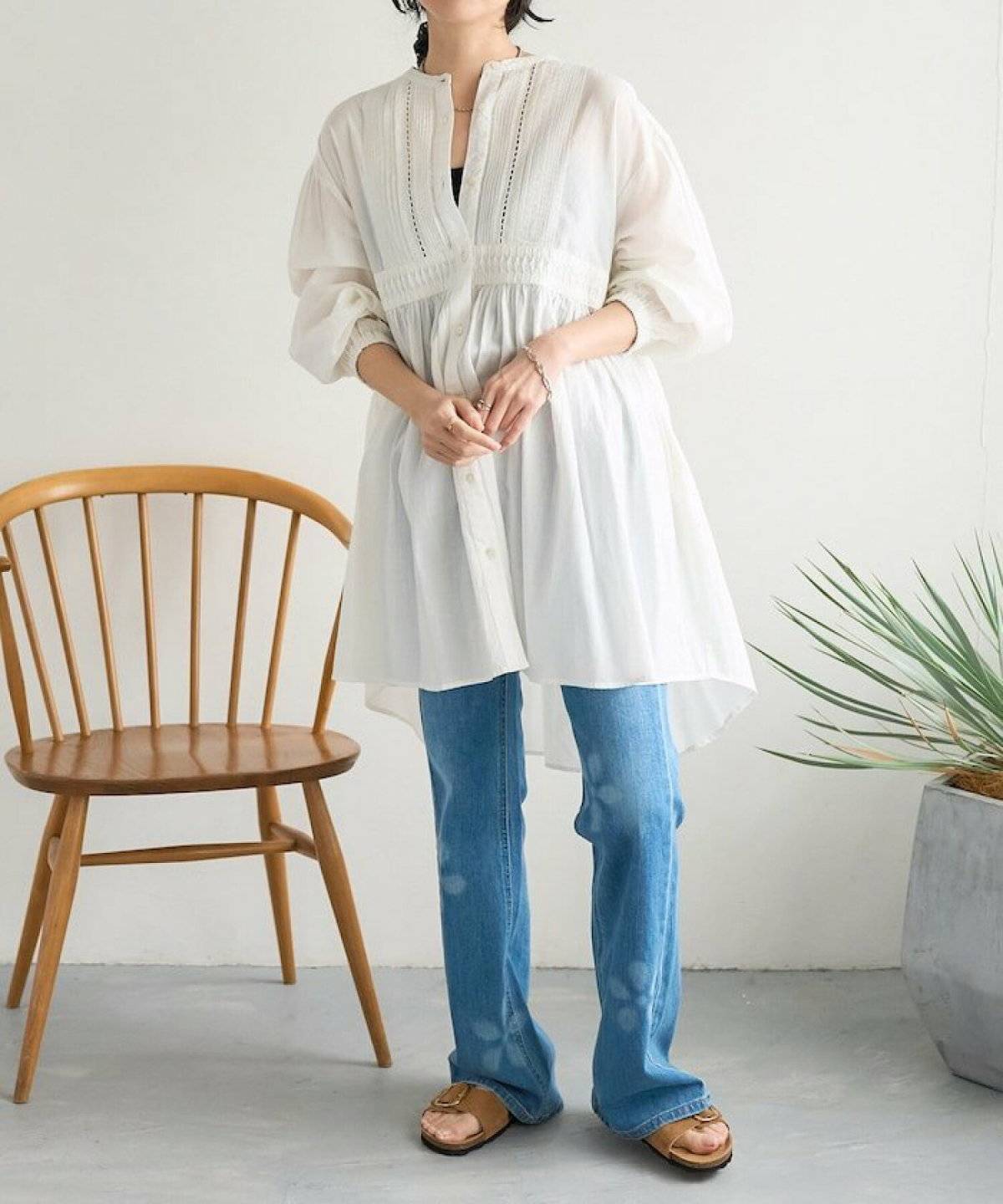 白ブラウスにデニムを合わせた女性