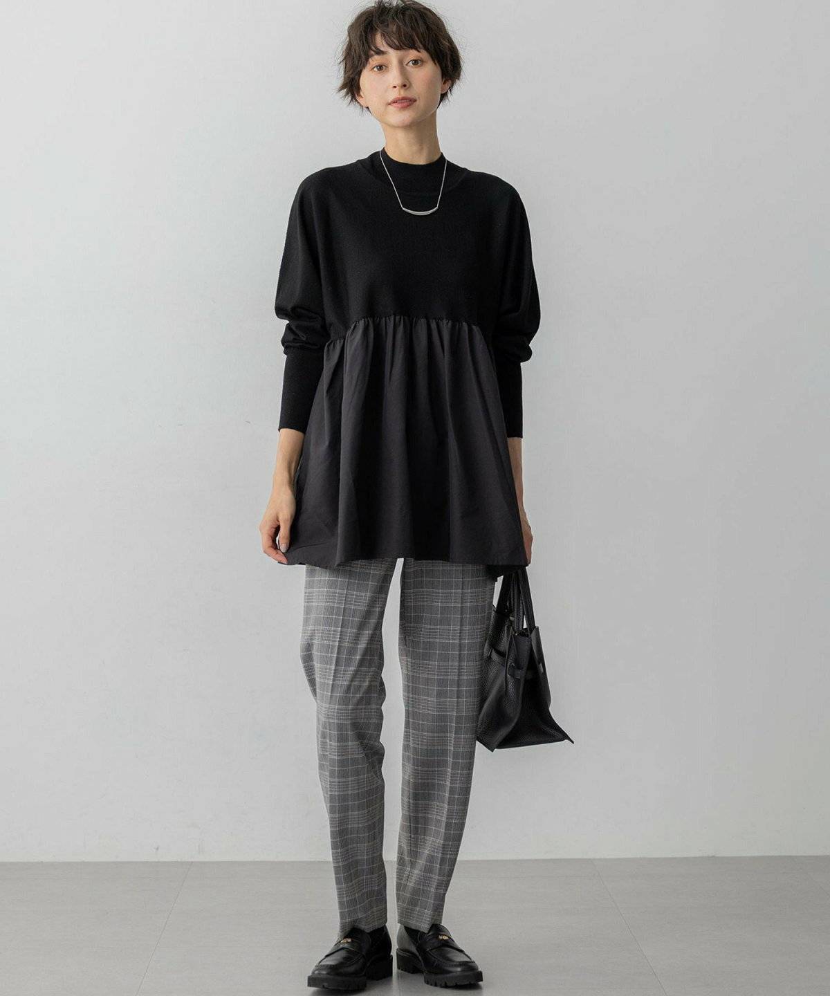 グレーのチェックパンツの女性